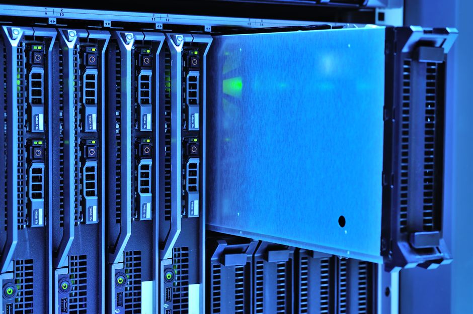 Vista detalhada de racks de servidores com luzes brilhantes em um ambiente de data center.